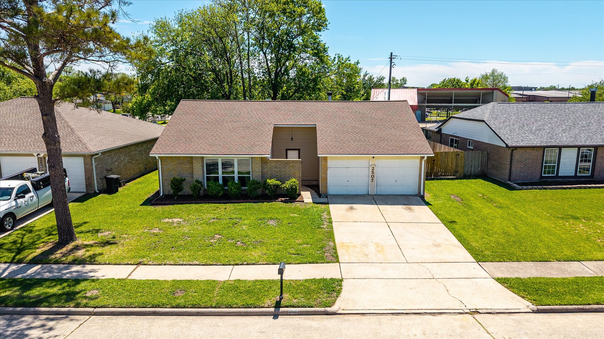 Take in a wide view of this well-kept single story with a clean brick exterior, mature shade trees, and a full two-car garage. The extended driveway and generous front yard offer great spacing between neighbors and a welcoming first impression.