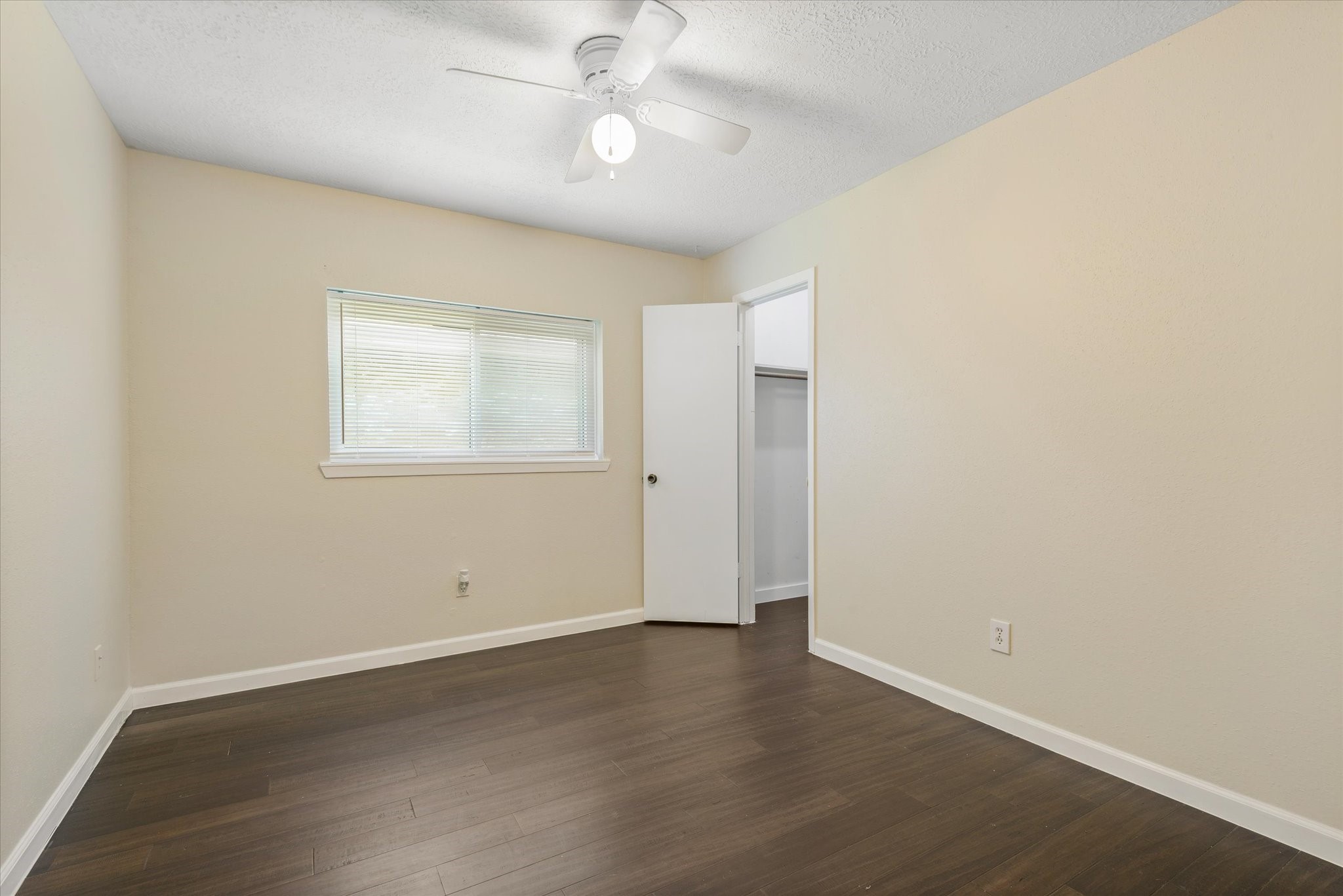 2507 Kings Chapel Road Friendswood, TX 77546 - Photo 17 of 28 Another secondary bedroom highlights the spacious layout, durable flooring, and easy access to the closet. The neutral palette and natural light create a bright space ready for a variety of uses.