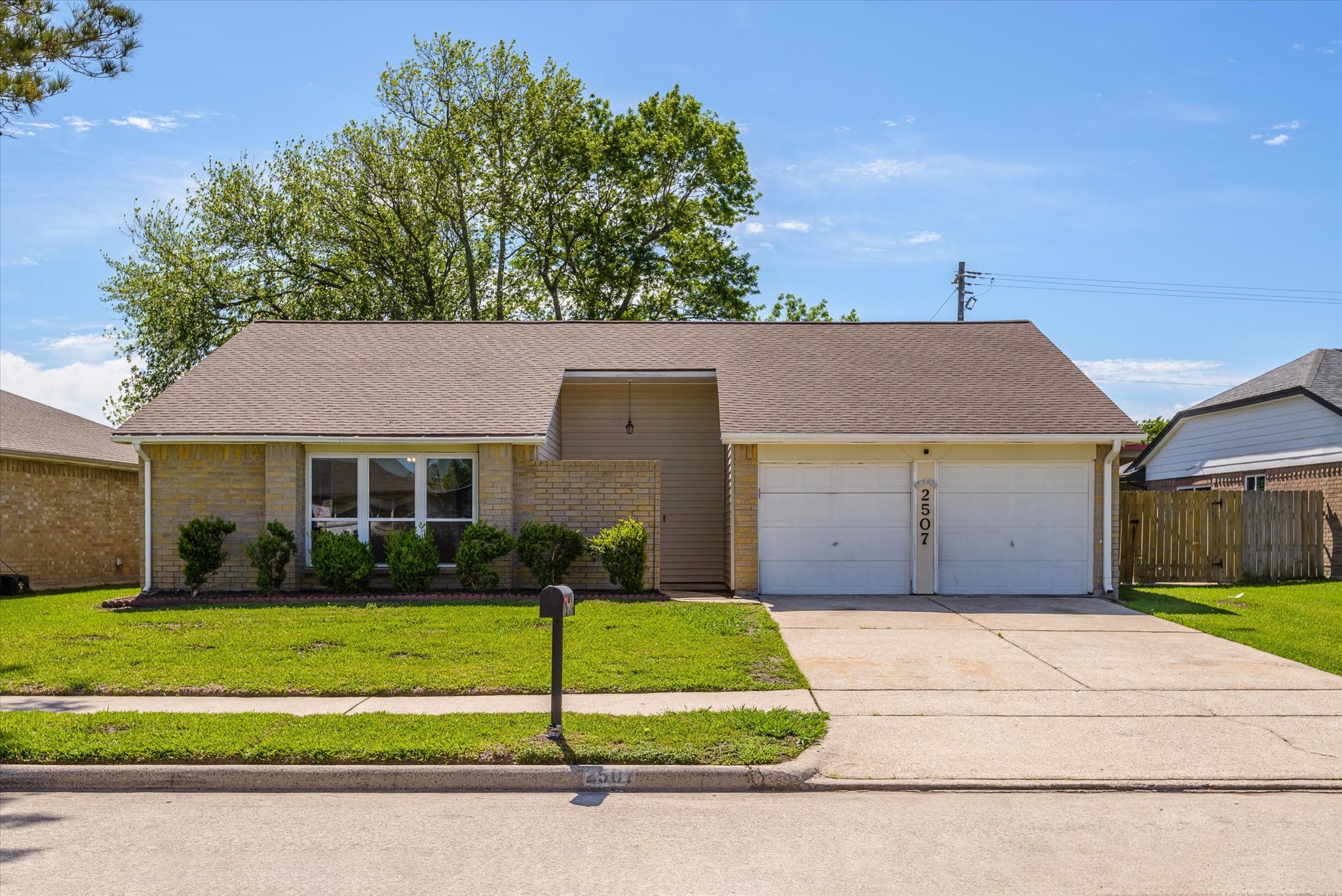 2507 Kings Chapel Road Friendswood, TX 77546 - Photo 2 of 28 Step up to this inviting front elevation with manicured landscaping, a freshly mulched bed, and a recessed covered entry. The double garage and clean rooflines give the home a balanced look, while the large front window brings in great natural light.