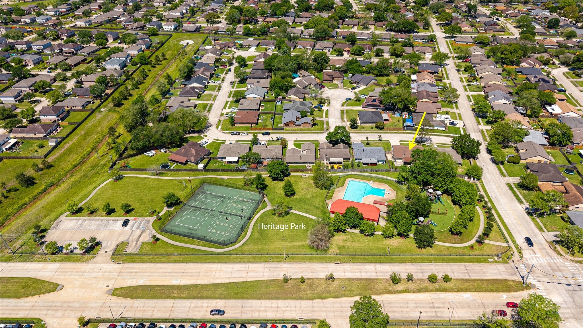 2507 Kings Chapel Road Friendswood, TX 77546 - Photo 27 of 28 A wider aerial view captures the full Heritage Park community with its tree-lined streets, recreational areas, and established homes. The home’s location within the neighborhood offers both convenience and a true residential feel.