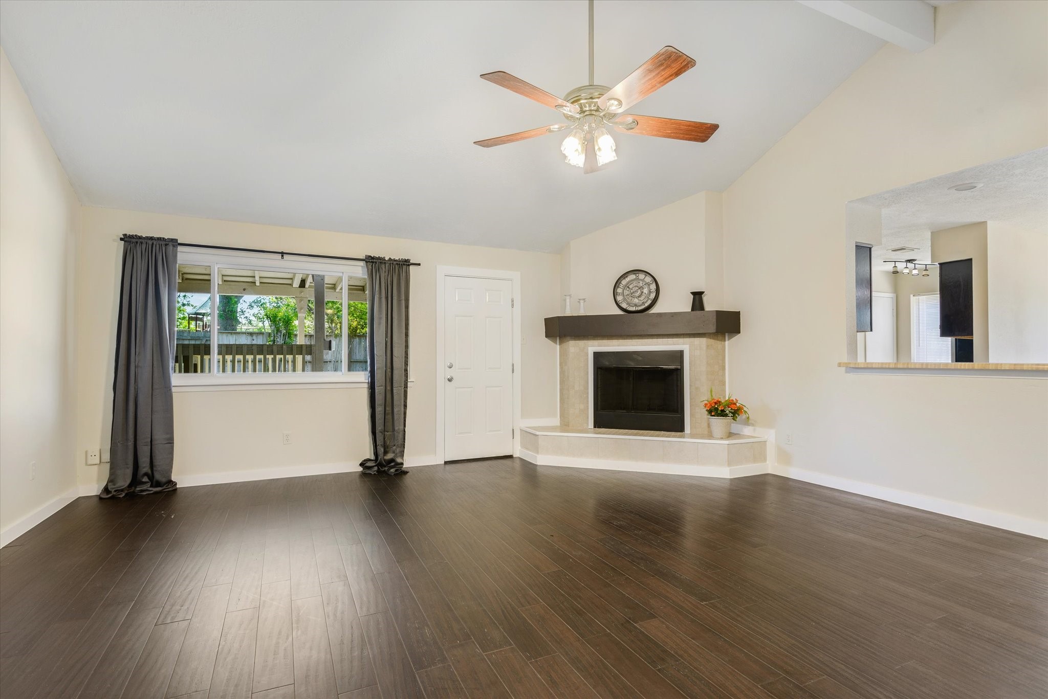 2507 Kings Chapel Road Friendswood, TX 77546 - Photo 6 of 28 From this angle, the remodeled fireplace becomes a focal point with its updated mantle and raised hearth seating. A large window and nearby door bring in natural light and offer views of the backyard and covered patio.