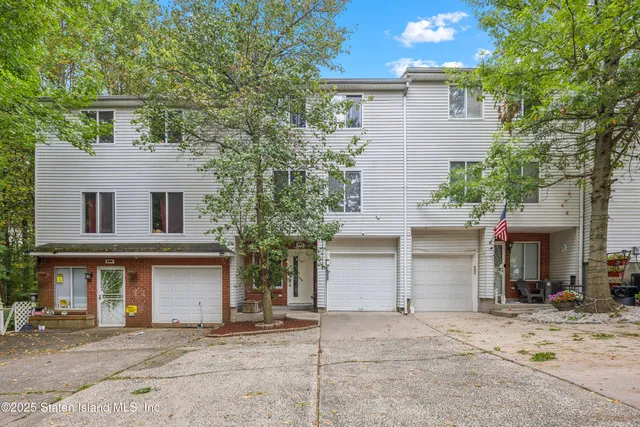 a front view of a house with a yard and a garage