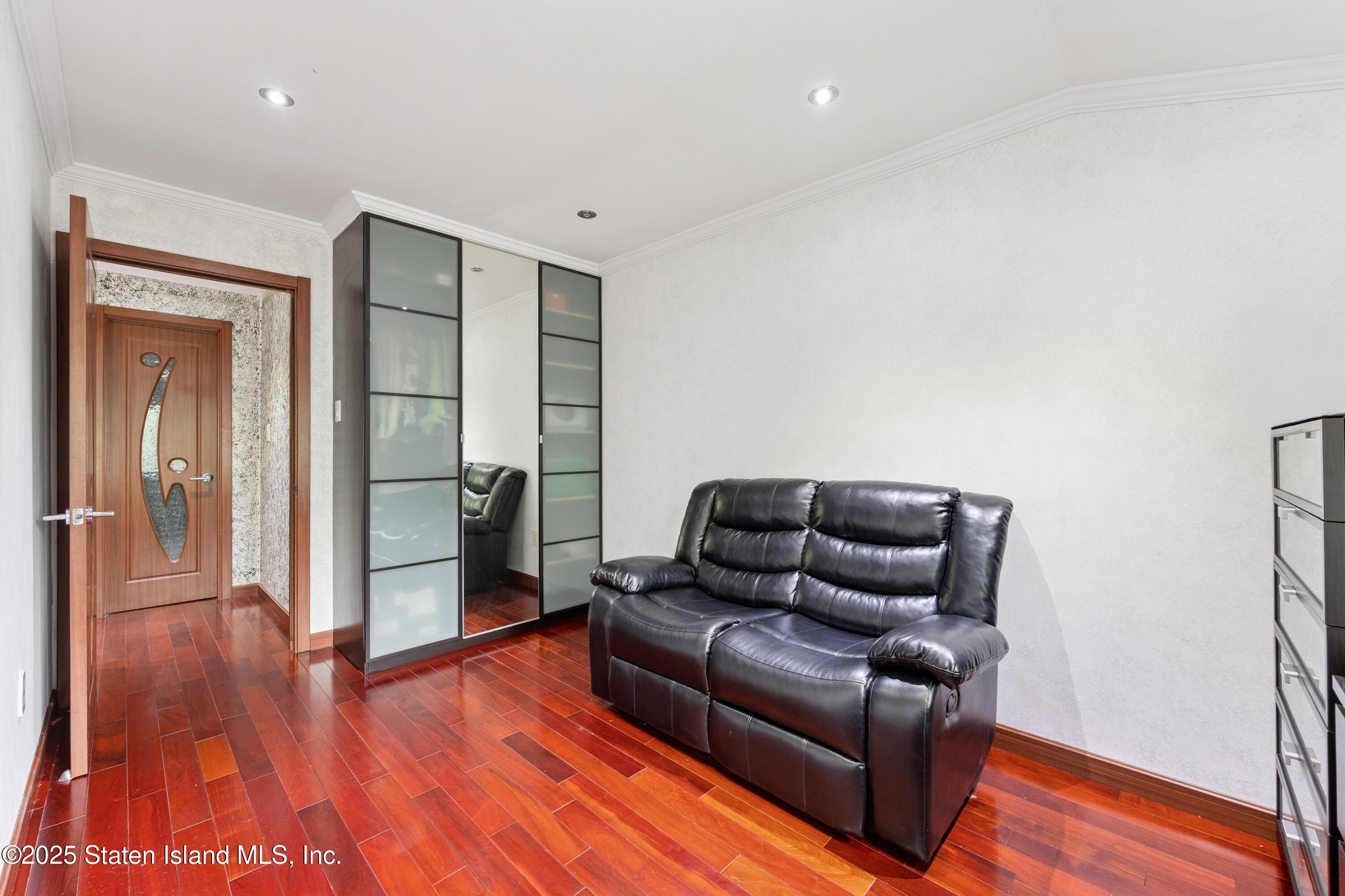 192 Ilyssa Way Staten Island, NY 10312 - Photo 13 of 25 a living room with furniture and a wooden floor