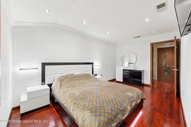 a bedroom with a bed and a view of kitchen