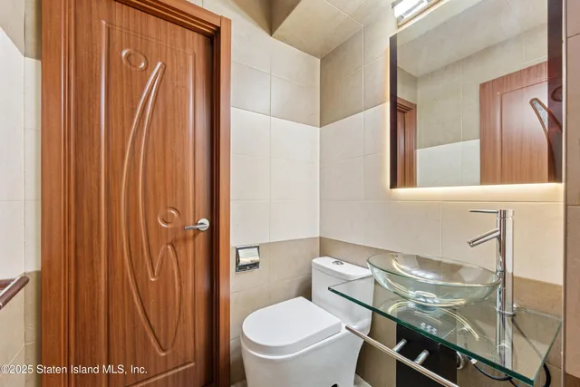 a white toilet sitting next to a bathroom sink