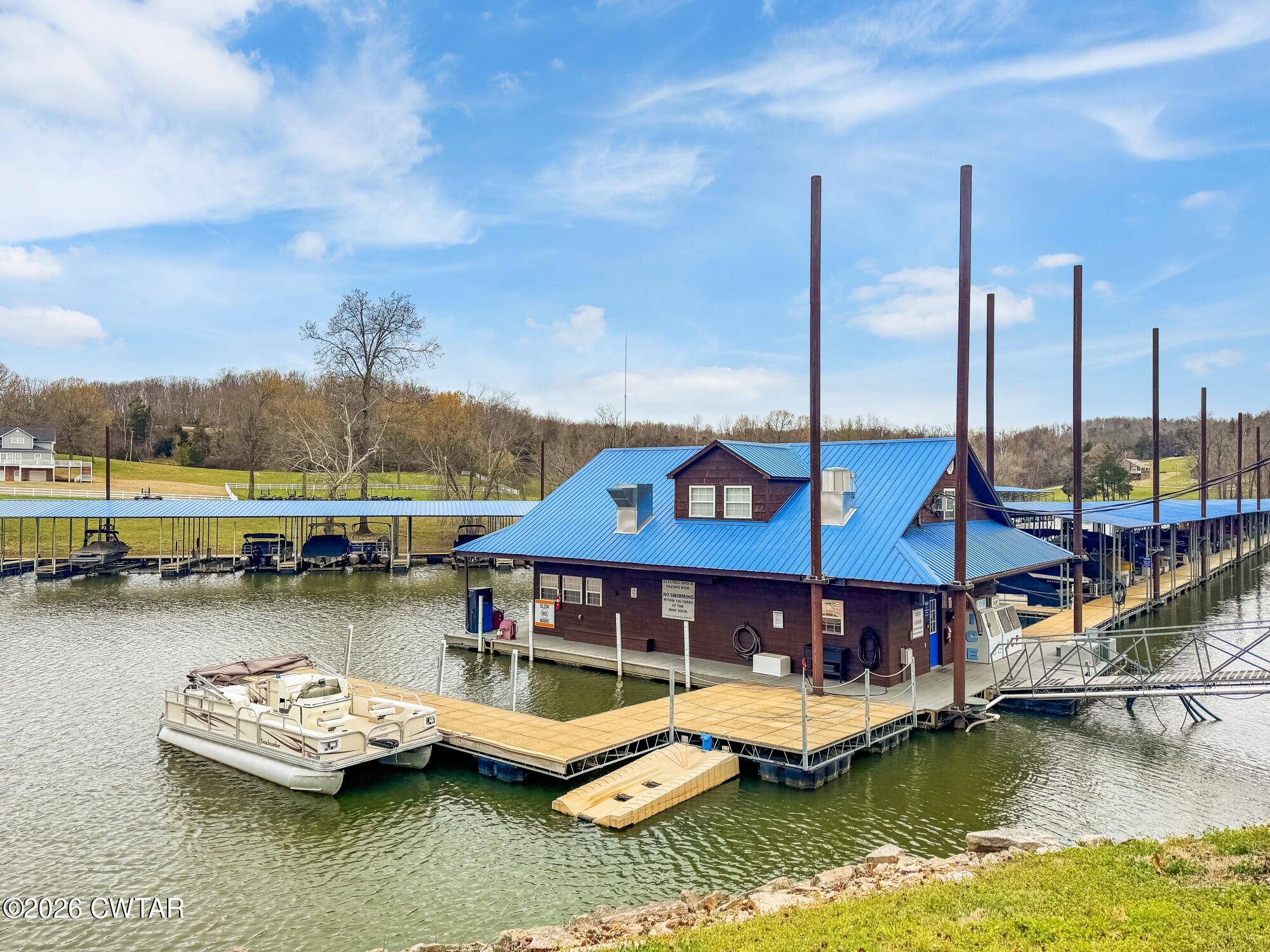 Lot 46 Adam Loop Bath Springs, TN 38311 - Photo 13 of 22 a small pool with lawn chairs in the lake