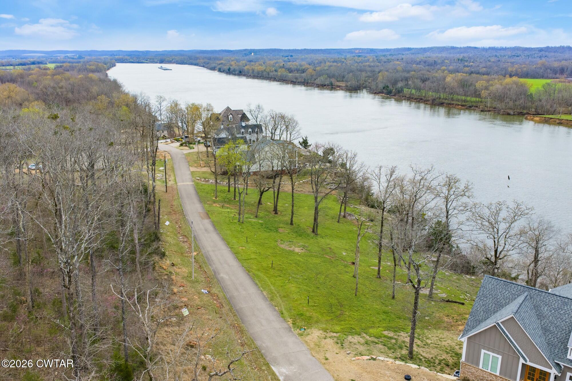 Lot 46 Adam Loop Bath Springs, TN 38311 - Photo 16 of 22 a view of a lake with a big yard