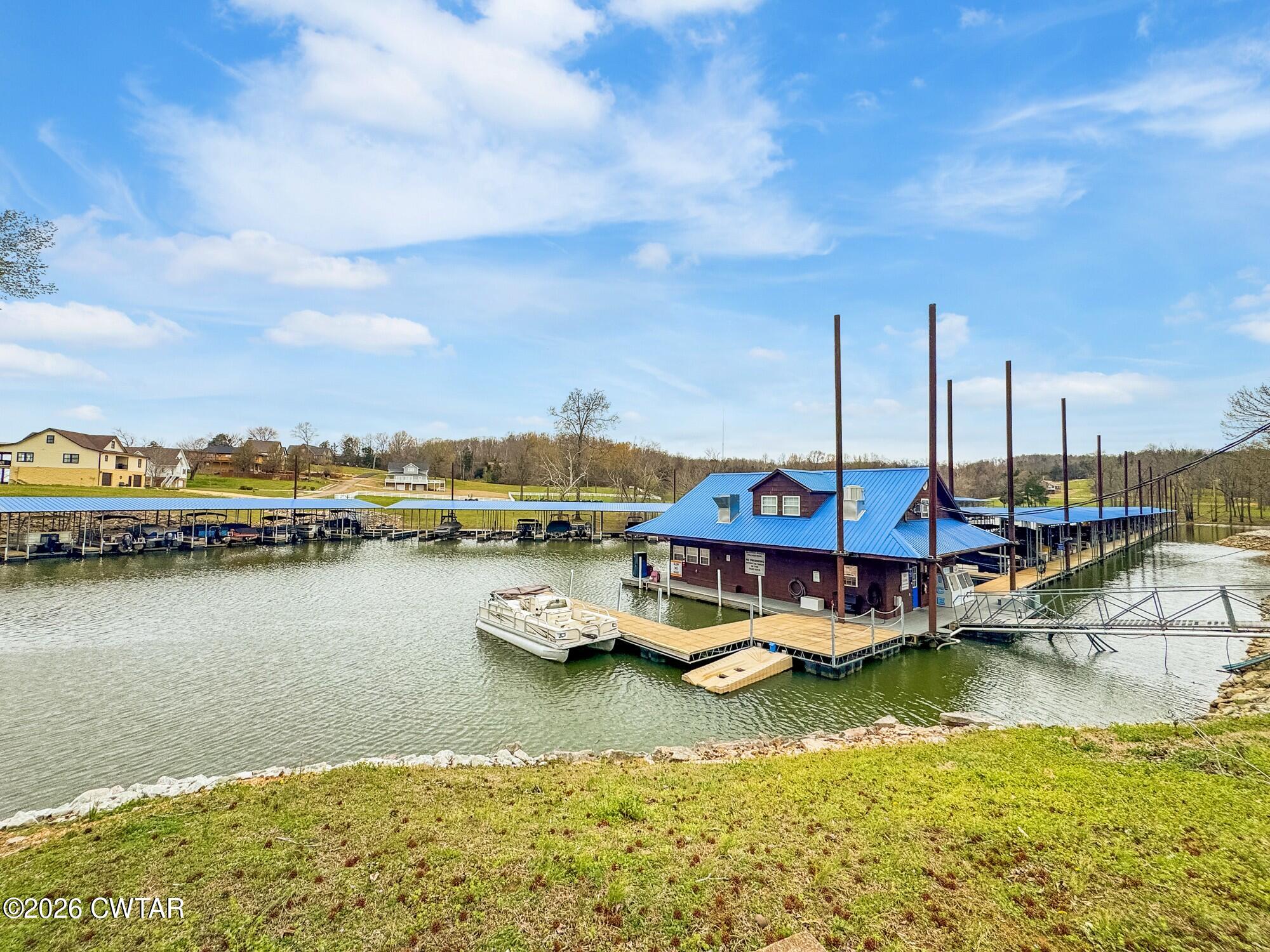 Lot 46 Adam Loop Bath Springs, TN 38311 - Photo 20 of 22 a view of a lake with boats and trees in the background