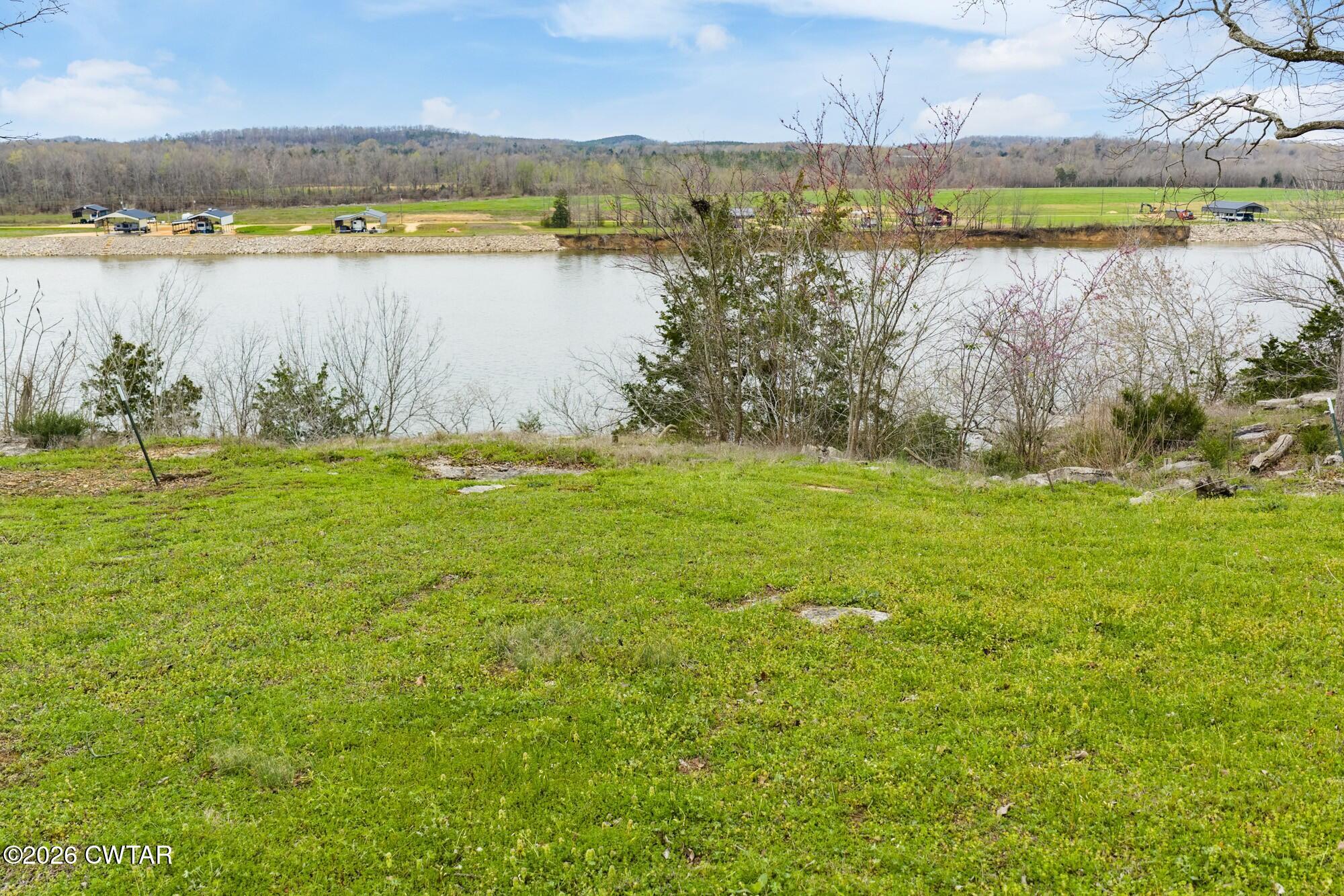 Lot 46 Adam Loop Bath Springs, TN 38311 - Photo 10 of 22 a view of a lake with houses in the back