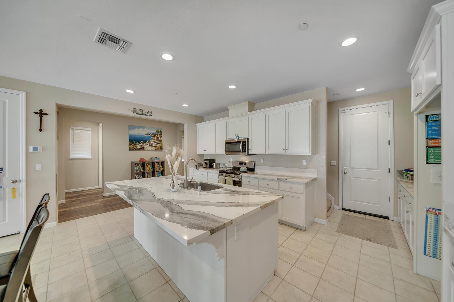 818 Stickney Way Oakley, CA 94561 - Photo 37 of 53 a kitchen with a sink a stove a refrigerator and white cabinets