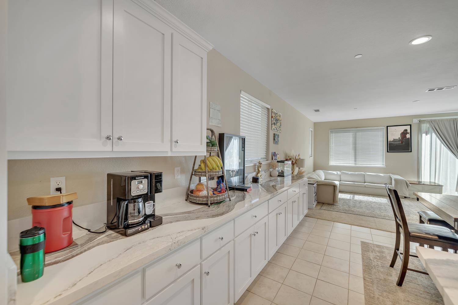 818 Stickney Way Oakley, CA 94561 - Photo 9 of 53 a large white kitchen with cabinets and chairs