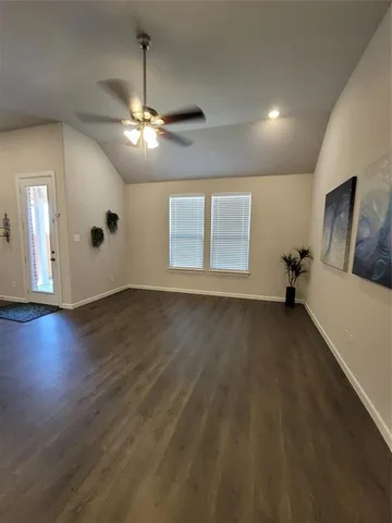 a view of a livingroom with a ceiling fan and window