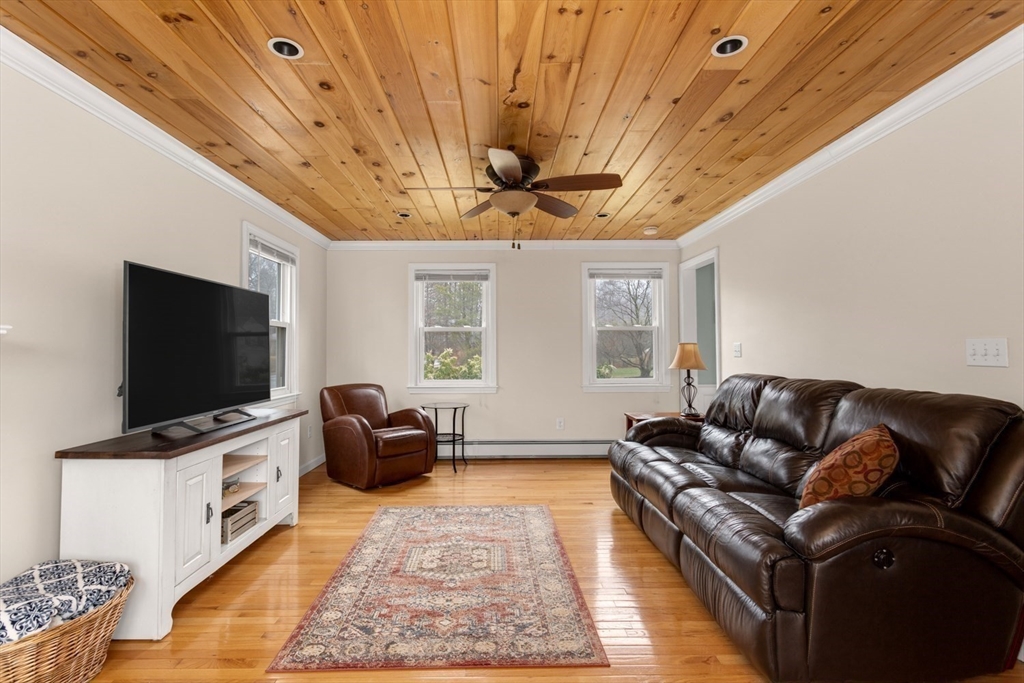 426 Coronation Drive Franklin, MA 02038 - Photo 14 of 46 a living room with furniture and a flat screen tv