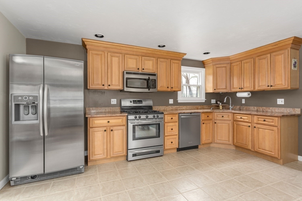 426 Coronation Drive Franklin, MA 02038 - Photo 2 of 46 a kitchen with stainless steel appliances granite countertop a refrigerator sink and stove