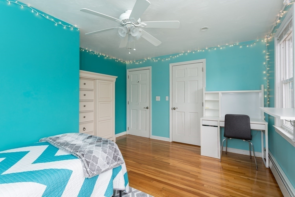 426 Coronation Drive Franklin, MA 02038 - Photo 23 of 46 a bedroom with a bed and a chandelier