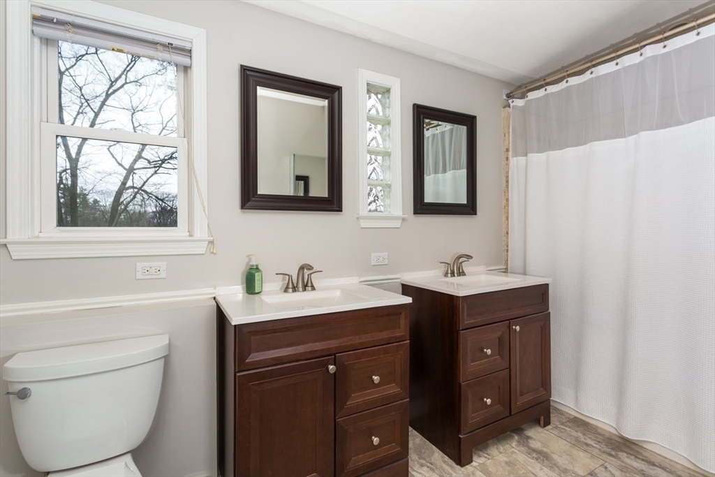 426 Coronation Drive Franklin, MA 02038 - Photo 27 of 46 a bathroom with a toilet sink and mirror