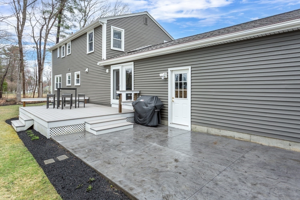 426 Coronation Drive Franklin, MA 02038 - Photo 30 of 46 a view of a patio with table and chairs and wooden fence