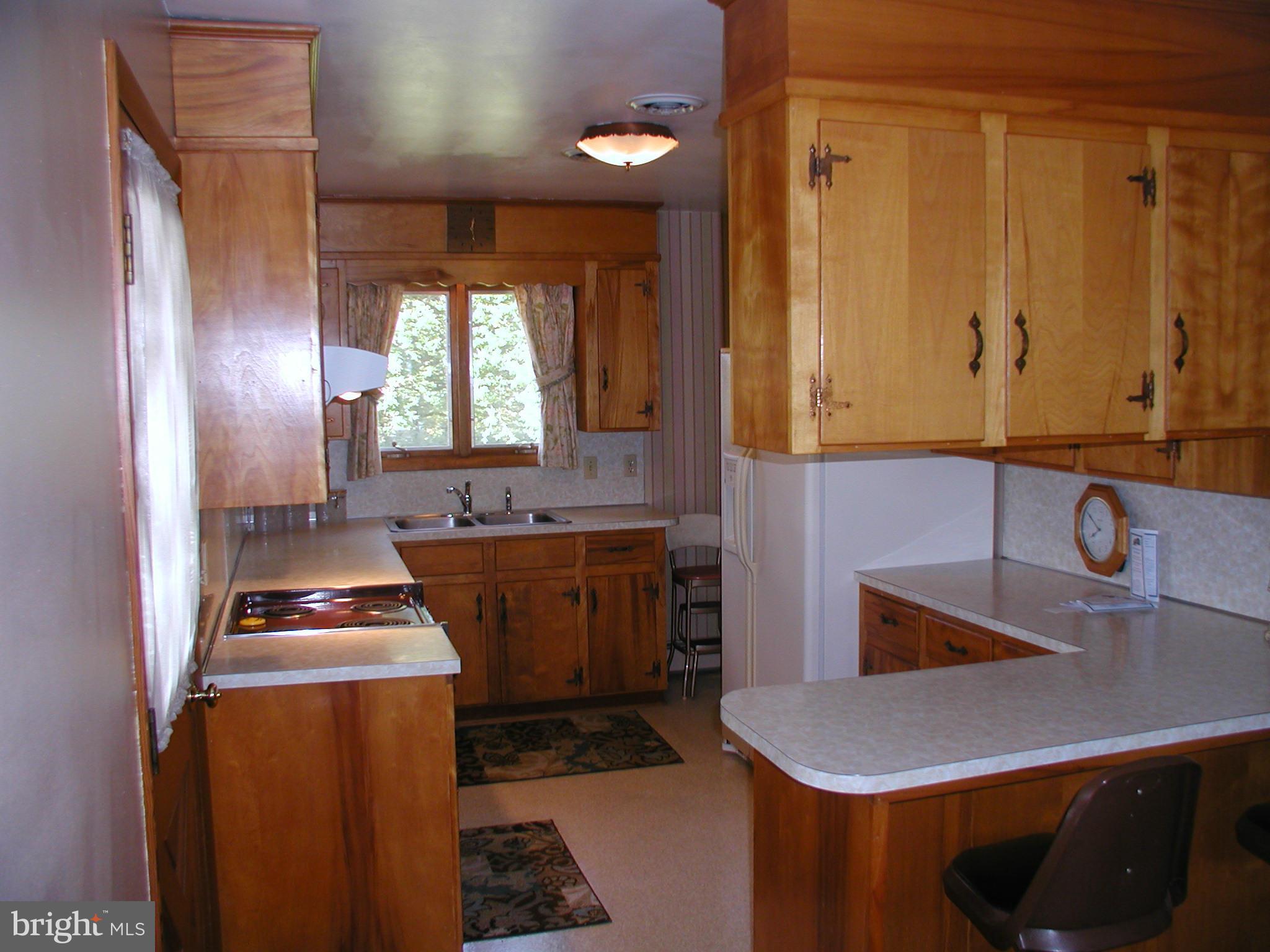 8834 Yellow Springs Road Frederick, MD 21702 - Photo 16 of 24 a room with kitchen island a sink a stove and a window