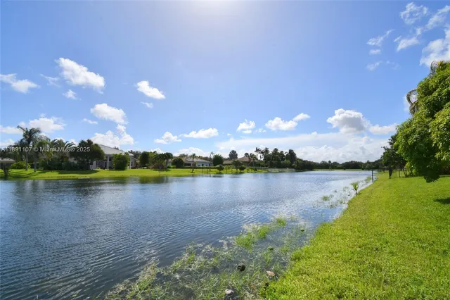 a view of a lake with houses in the back