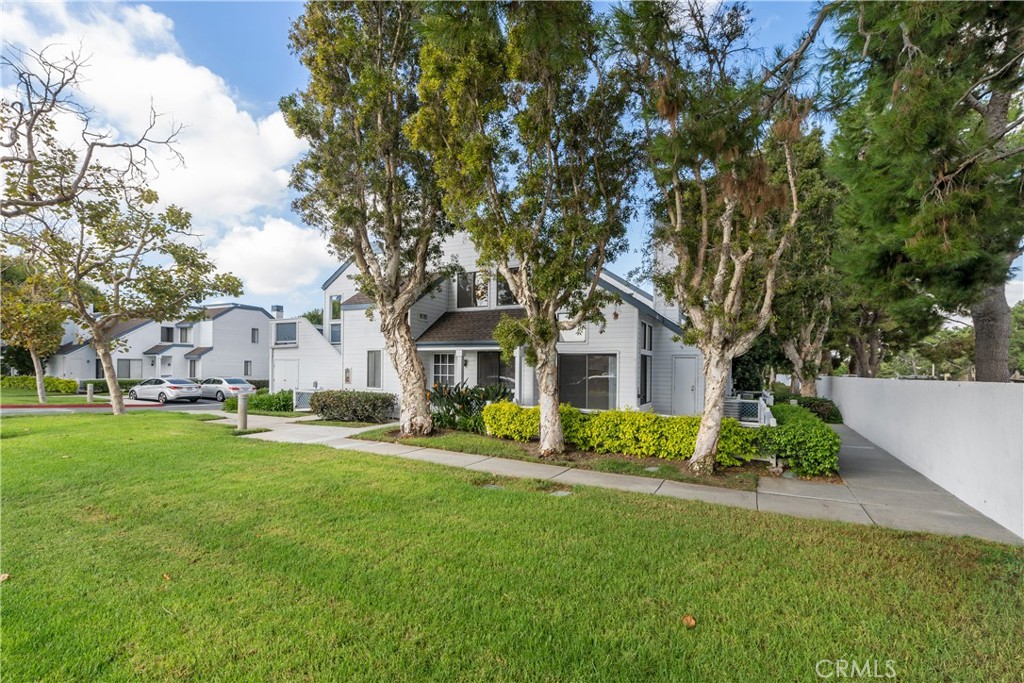 a front view of house with yard and green space