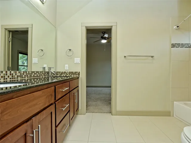 a bathroom with a shower sink and mirror