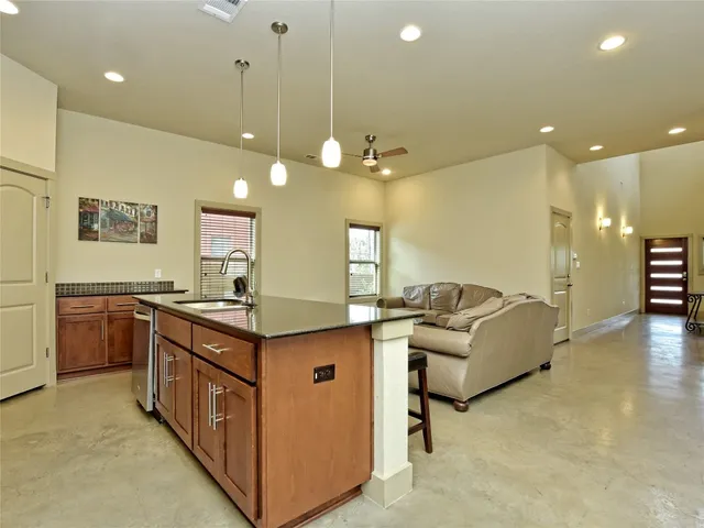 a kitchen with stainless steel appliances granite countertop a stove and a sink