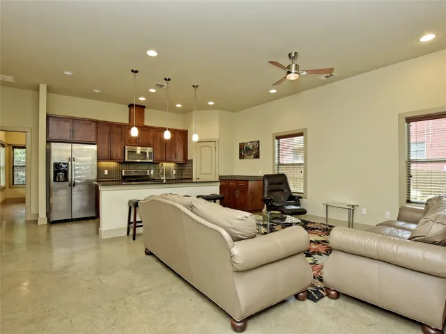 a living room with furniture and kitchen view