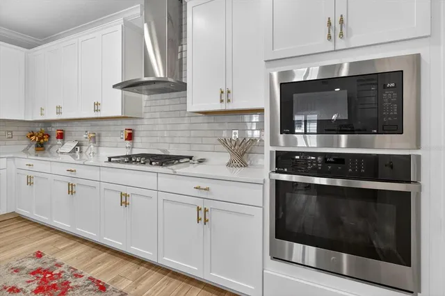 a kitchen with granite countertop white cabinets and stove