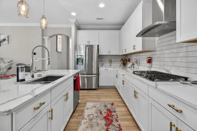 a kitchen with a stove a sink and a refrigerator
