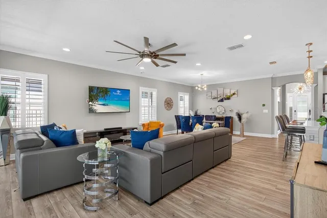 a living room with furniture and a view of kitchen