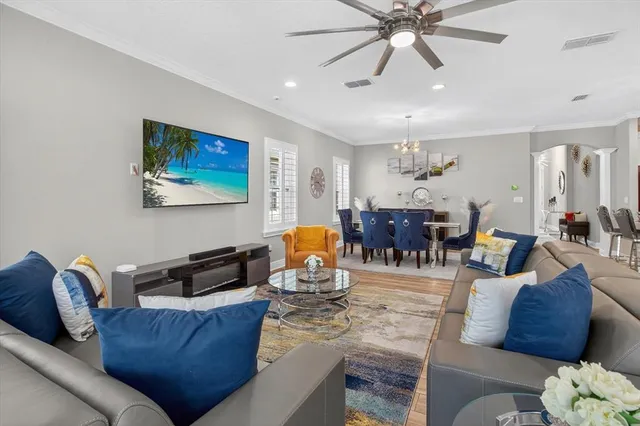 a living room with furniture and a chandelier