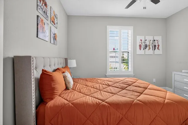 a bedroom with a bed and painting on the wall