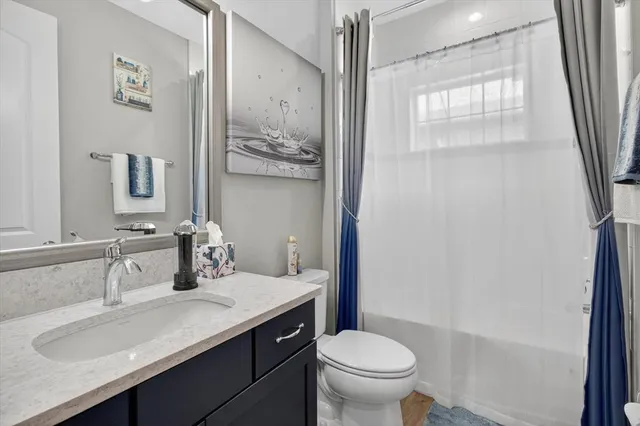 a bedroom with a bed and painting on the wall