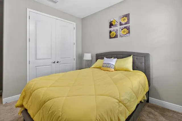 a bedroom with a bed and a painting on the wall