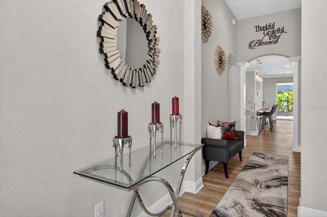 a kitchen with stainless steel appliances kitchen island granite countertop a dining table chairs refrigerator sink and cabinets