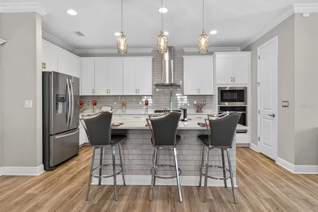 a kitchen with stainless steel appliances kitchen island granite countertop a sink and cabinets