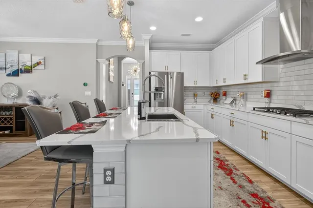 a large kitchen with stainless steel appliances granite countertop a sink and cabinets