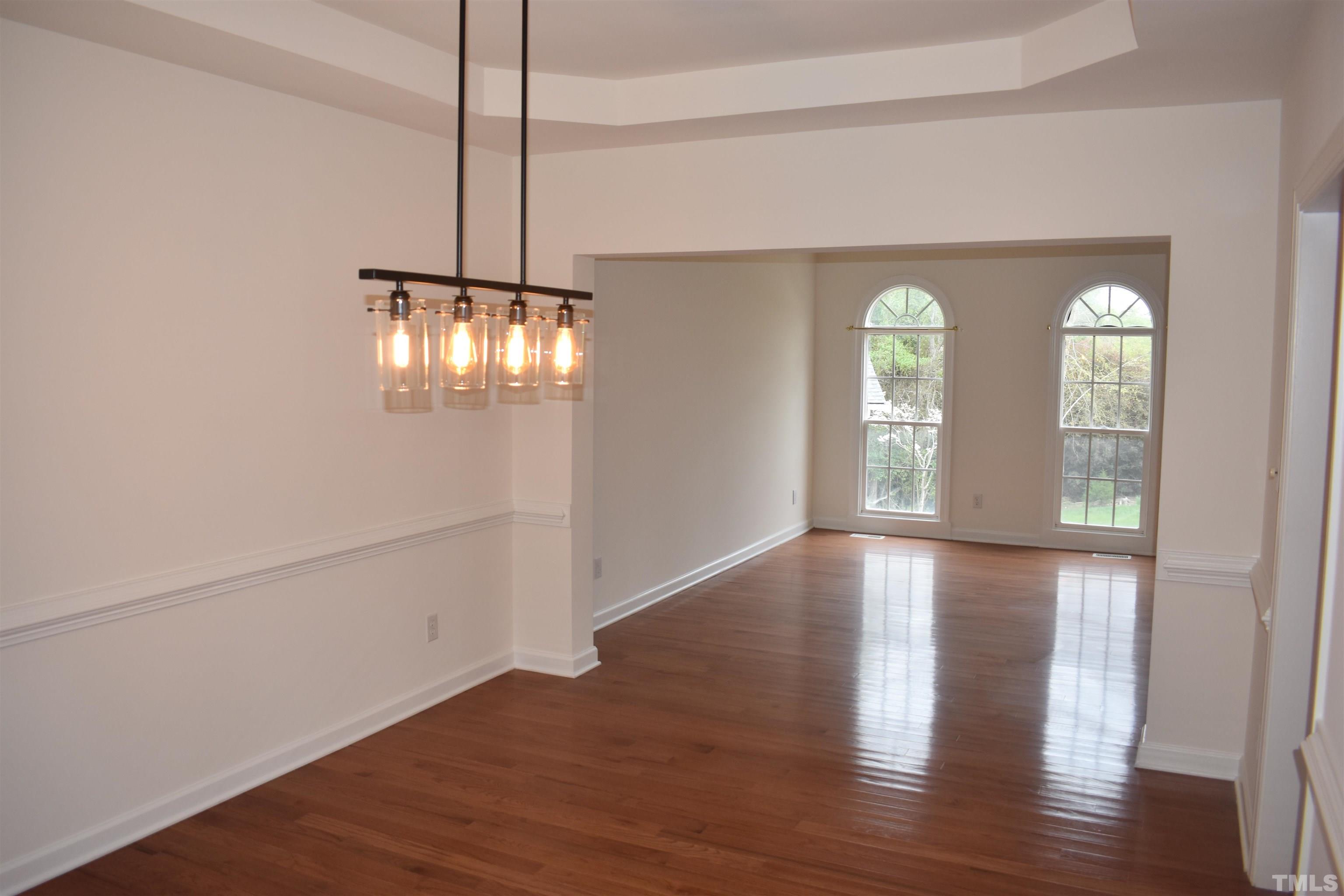 1504 Wood Spring Court Raleigh, NC 27614 - Photo 16 of 17 a view of an empty room with wooden floor and a window