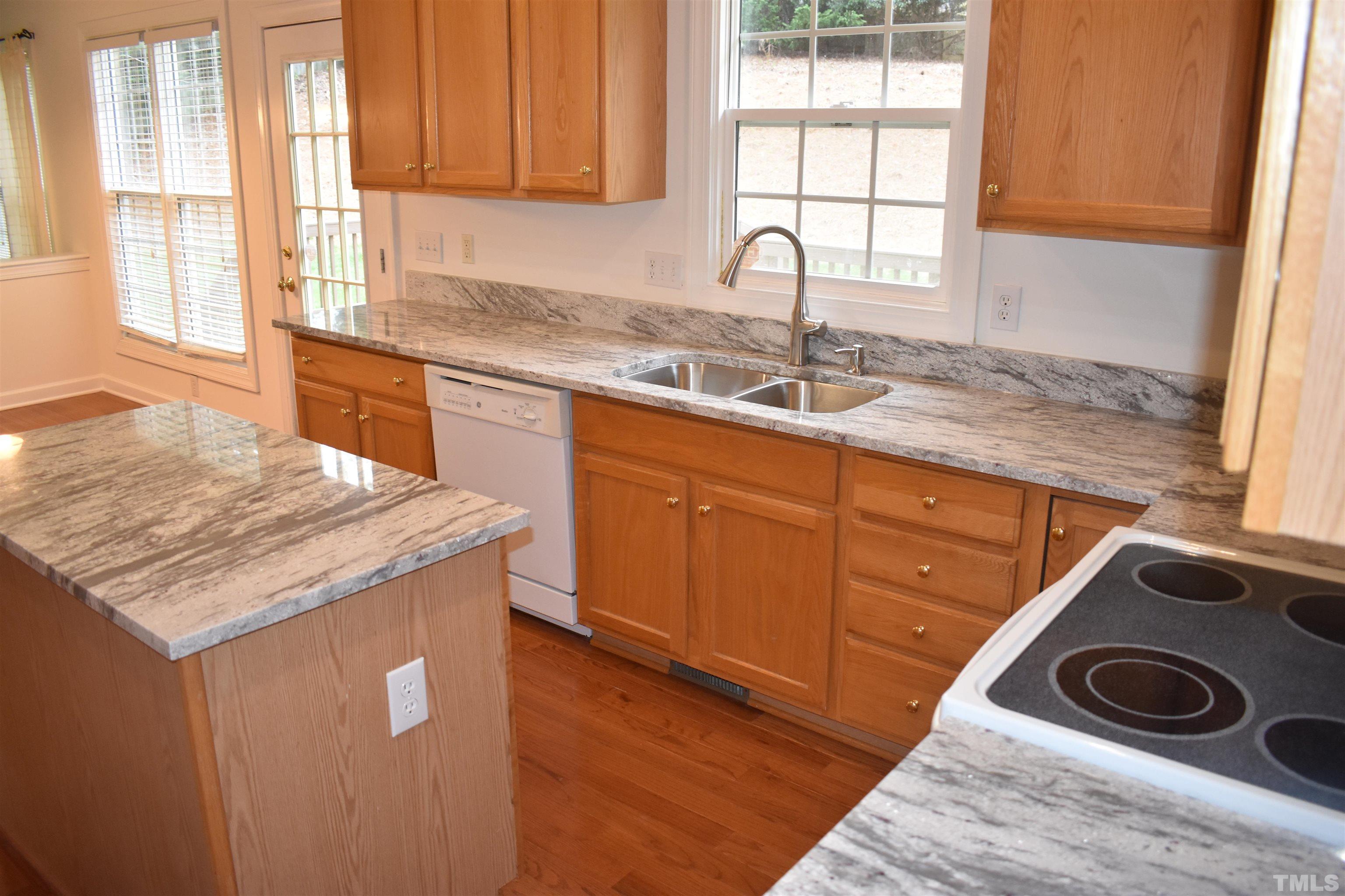 1504 Wood Spring Court Raleigh, NC 27614 - Photo 17 of 17 a kitchen with a sink stove and cabinets