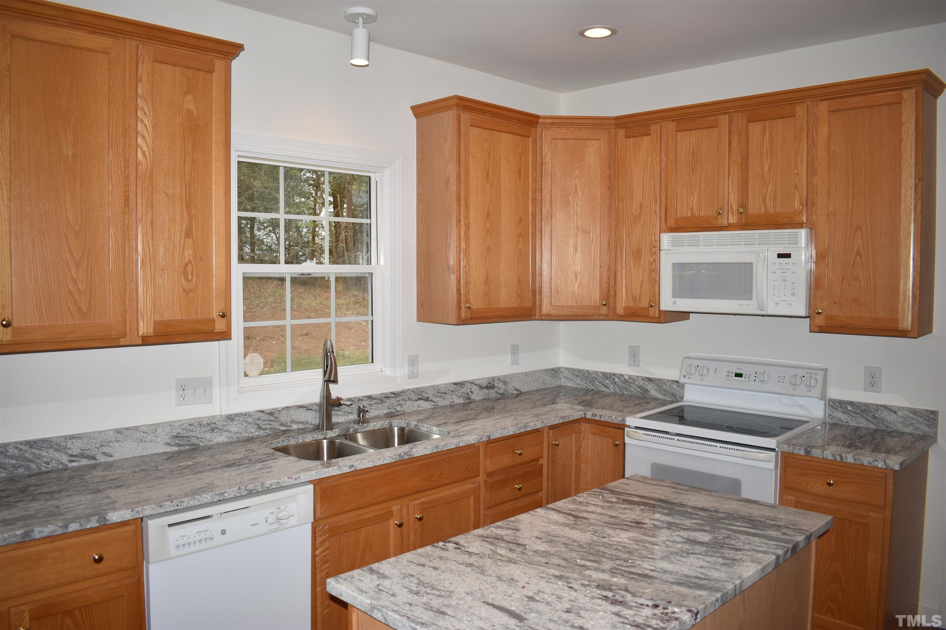 1504 Wood Spring Court Raleigh, NC 27614 - Photo 5 of 17 a kitchen with a sink cabinets and window