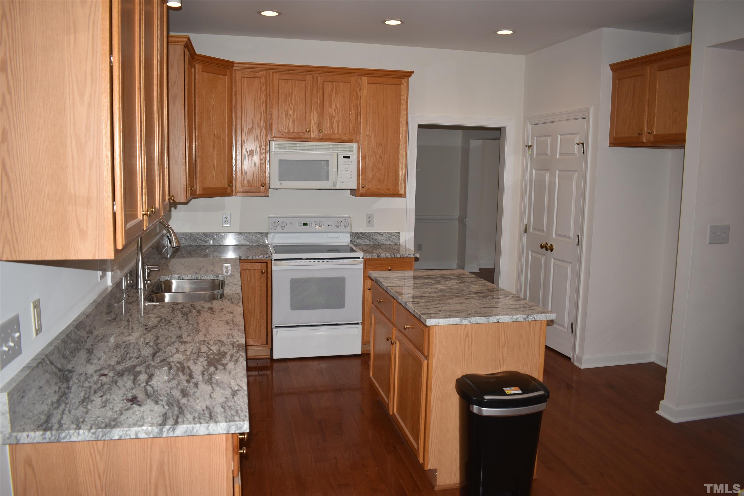 1504 Wood Spring Court Raleigh, NC 27614 - Photo 8 of 17 a kitchen that has a sink a stove and a refrigerator