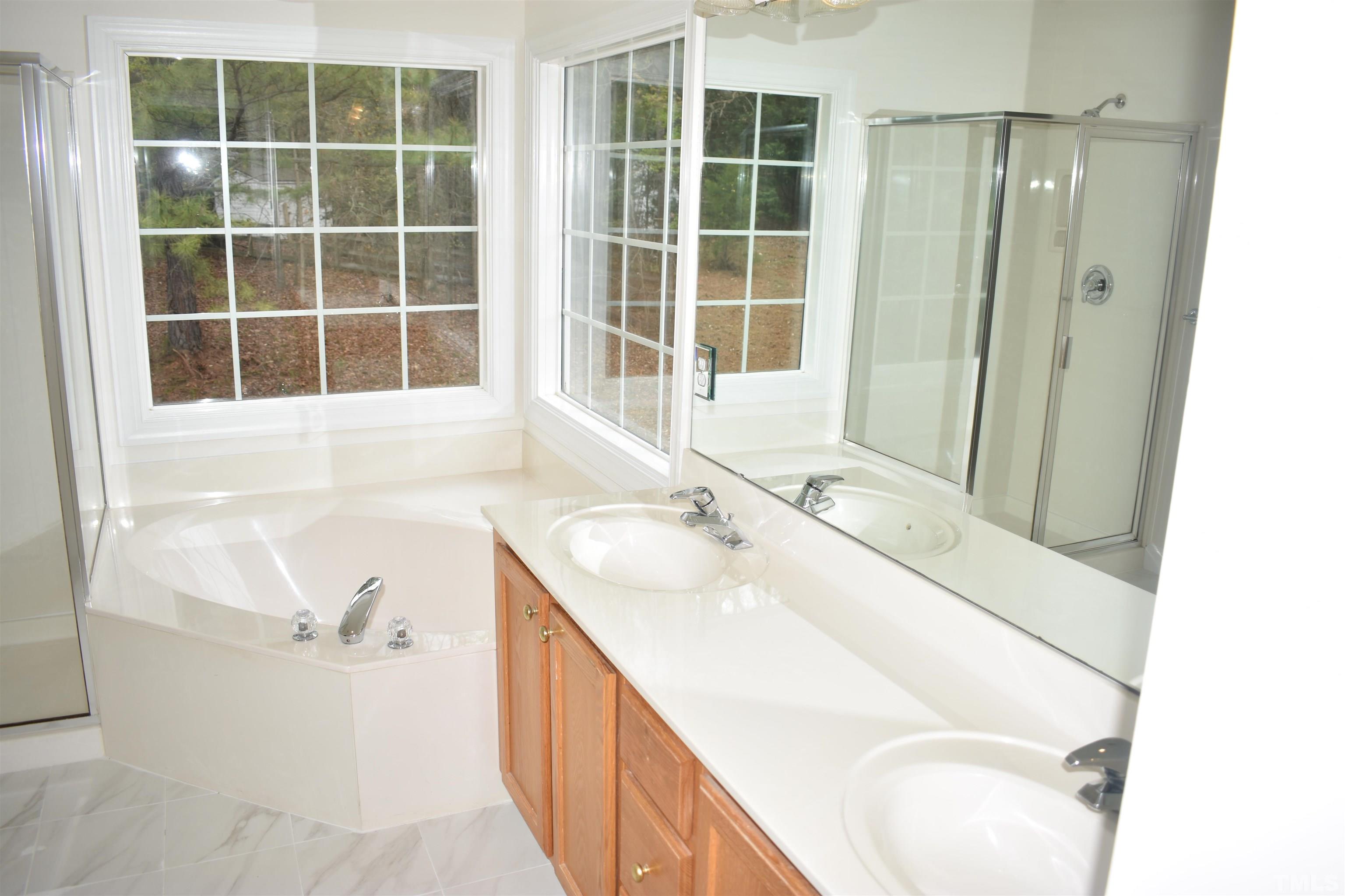 1504 Wood Spring Court Raleigh, NC 27614 - Photo 10 of 17 a bathroom with a sink and a bathtub