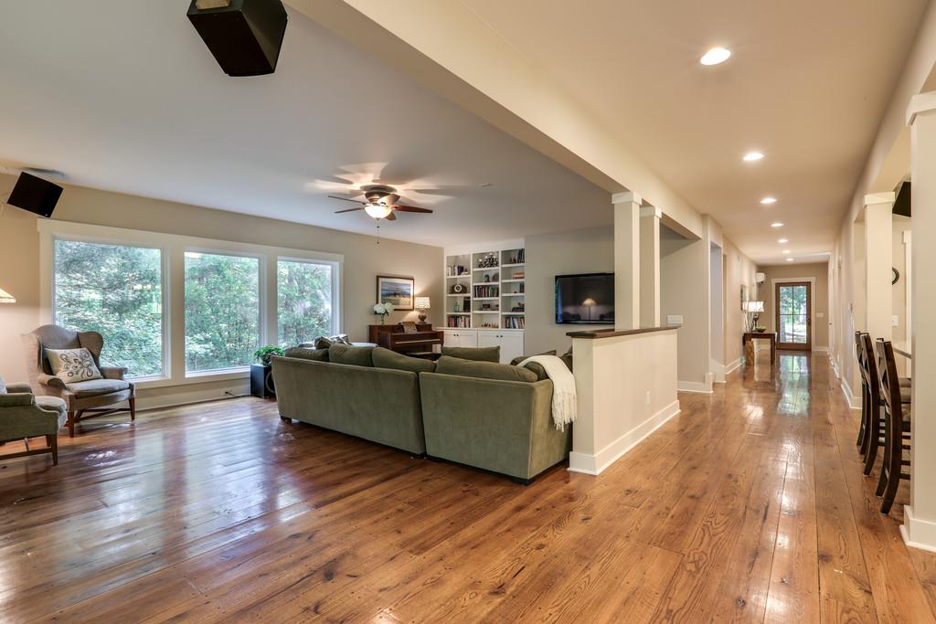 7833 Fernvale Road Fairview, TN 37062 - Photo 7 of 30 a living room with furniture a flat screen tv and wooden floor