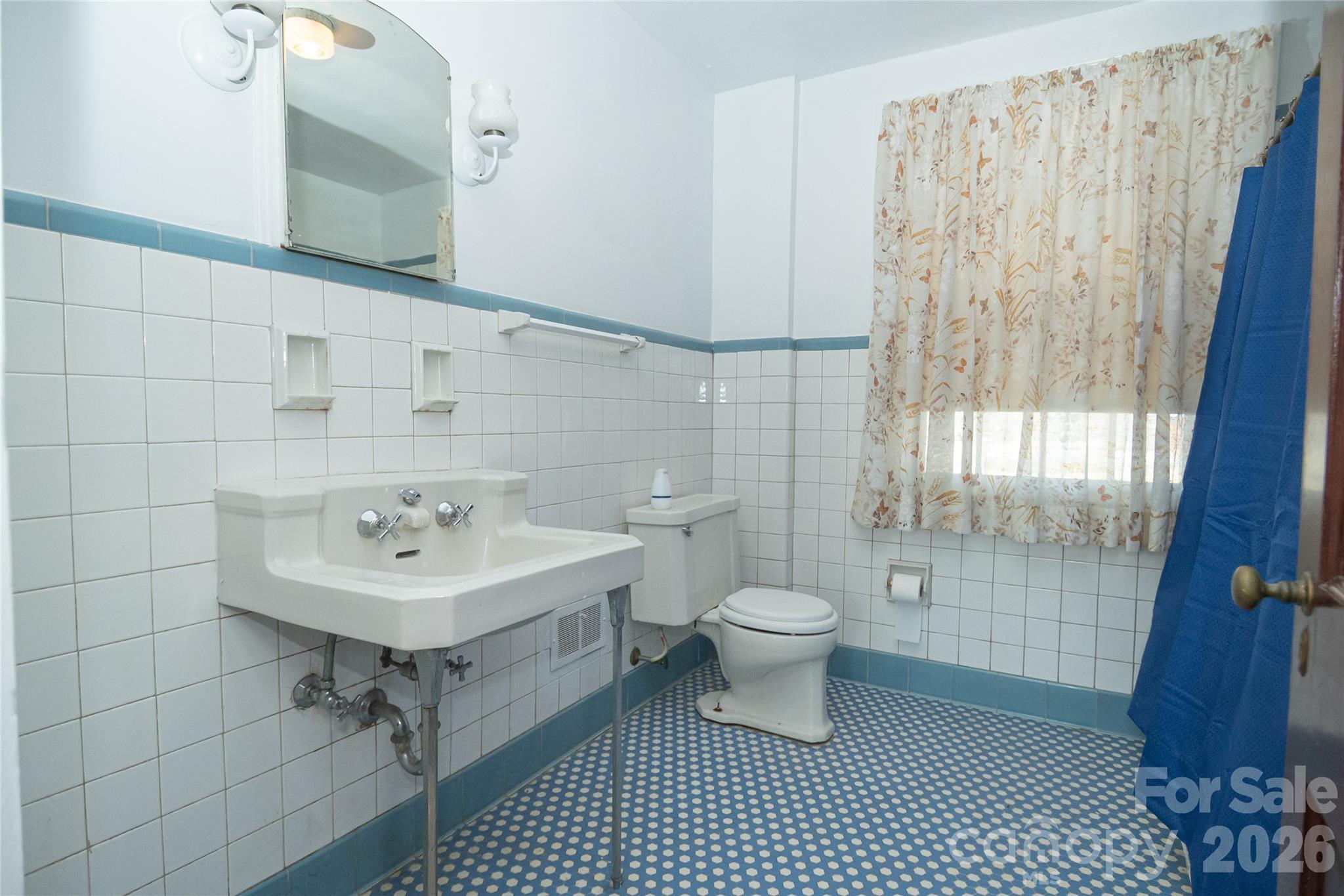 615 Carbon City Road Morganton, NC 28655 - Photo 23 of 42 a bathroom with a sink toilet a mirror and shower
