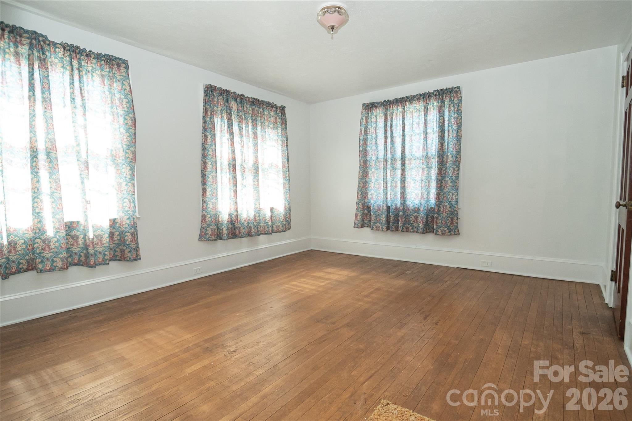 615 Carbon City Road Morganton, NC 28655 - Photo 29 of 42 an empty room with wooden floor and windows