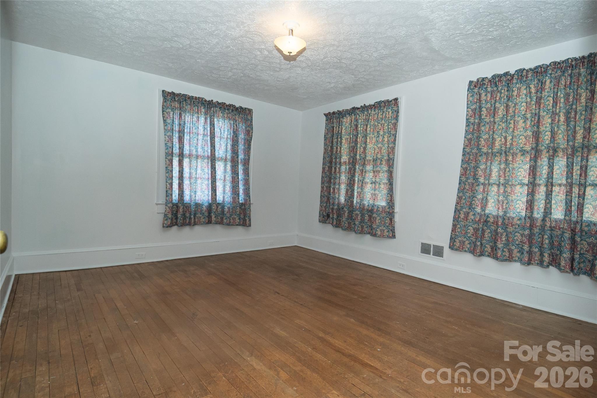 615 Carbon City Road Morganton, NC 28655 - Photo 30 of 42 a view of an empty room with wooden floor and a window