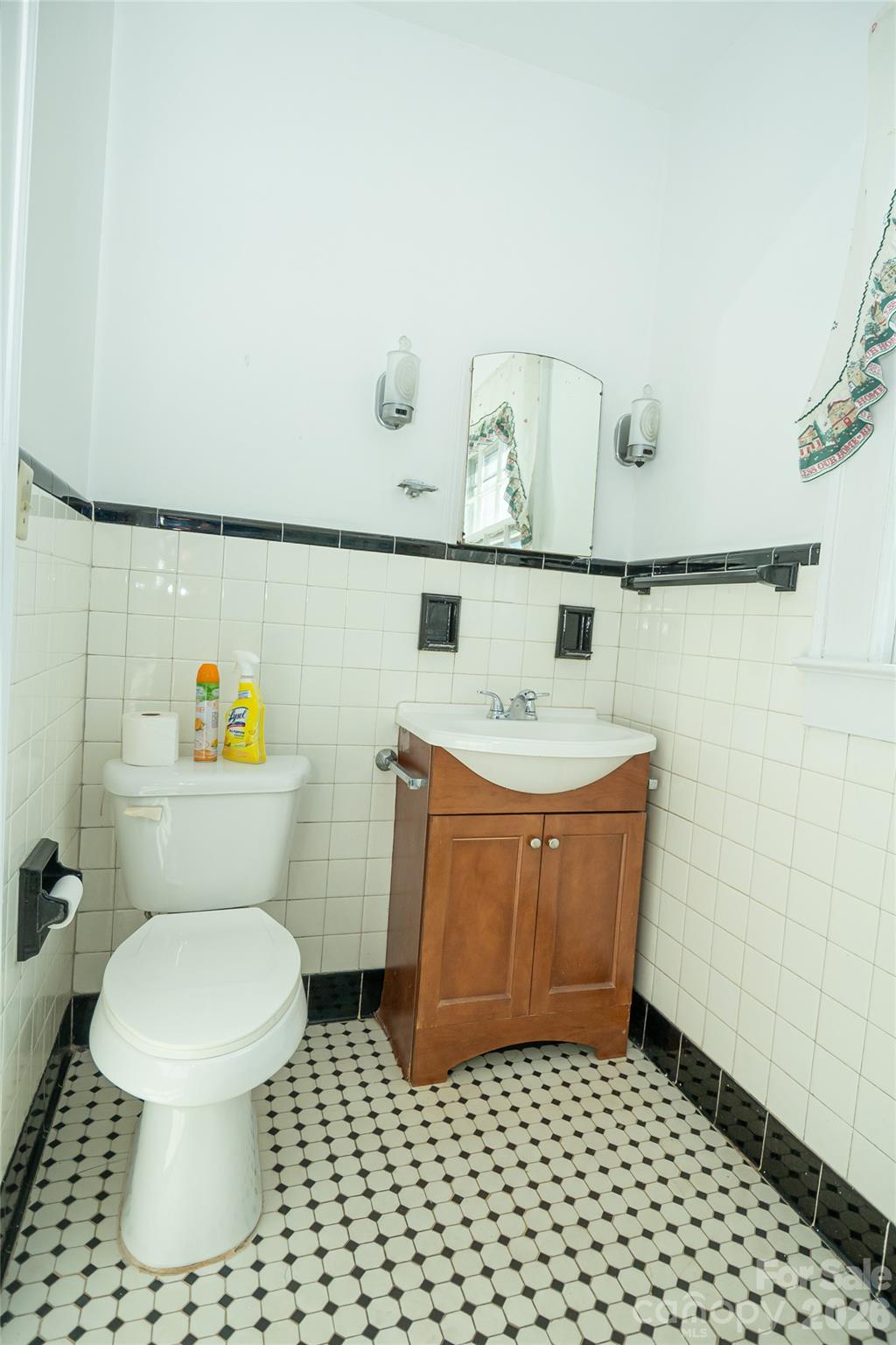 615 Carbon City Road Morganton, NC 28655 - Photo 32 of 42 a bathroom with a toilet a sink and mirror