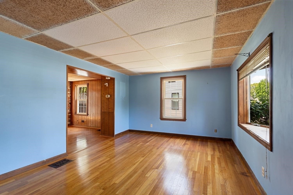 19 Butler Avenue Wakefield, MA 01880 - Photo 4 of 33 a view of an empty room with wooden floor and a window