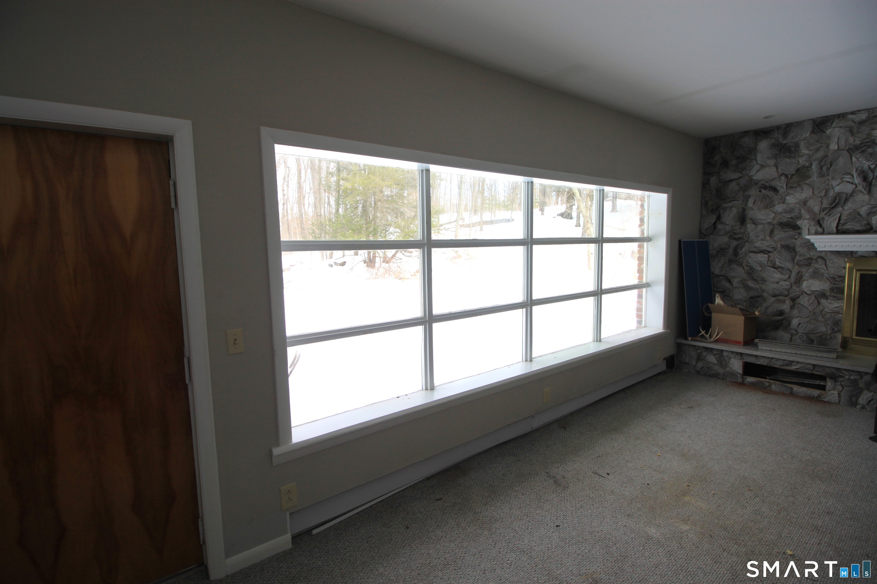 11 Old Fairwood Road Bethany, CT 06524 - Photo 14 of 20 a view of an empty room with a fireplace and a window