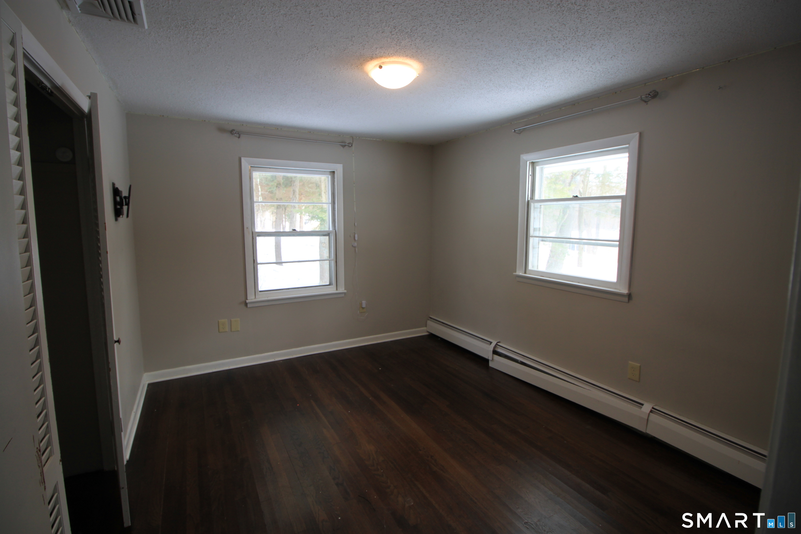11 Old Fairwood Road Bethany, CT 06524 - Photo 16 of 20 a view of an empty room with wooden floor and a window